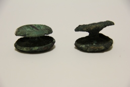 photograph of two copper ear spools