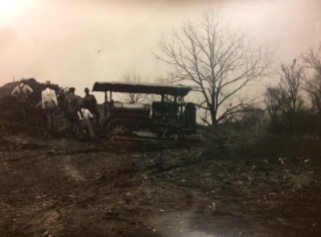 Tractor being used to excavate mound